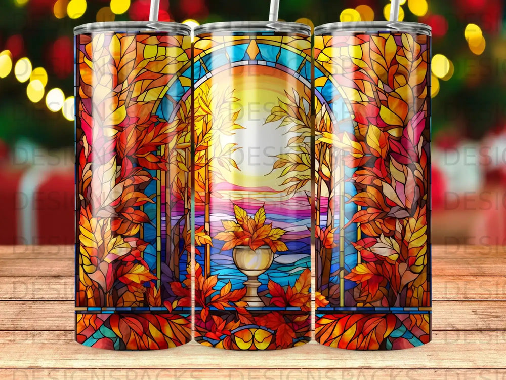 Stained glass tumbler with autumn leaves and sunset scene.
