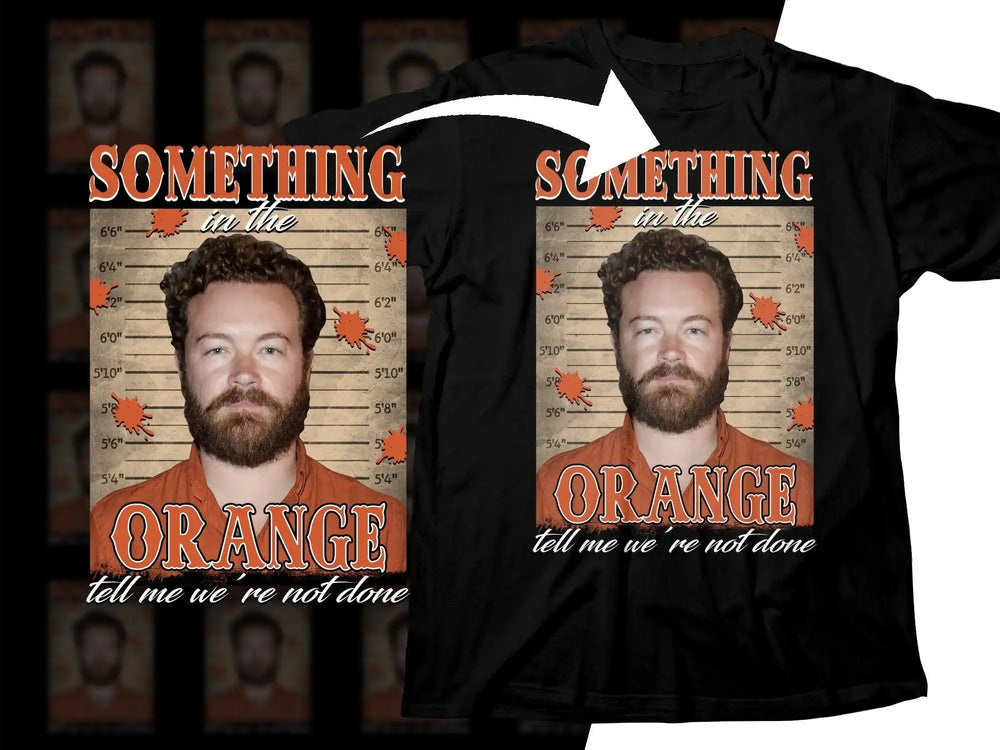 Black t-shirt with 'Something in the Orange' design featuring a mugshot-style graphic and orange splatters.