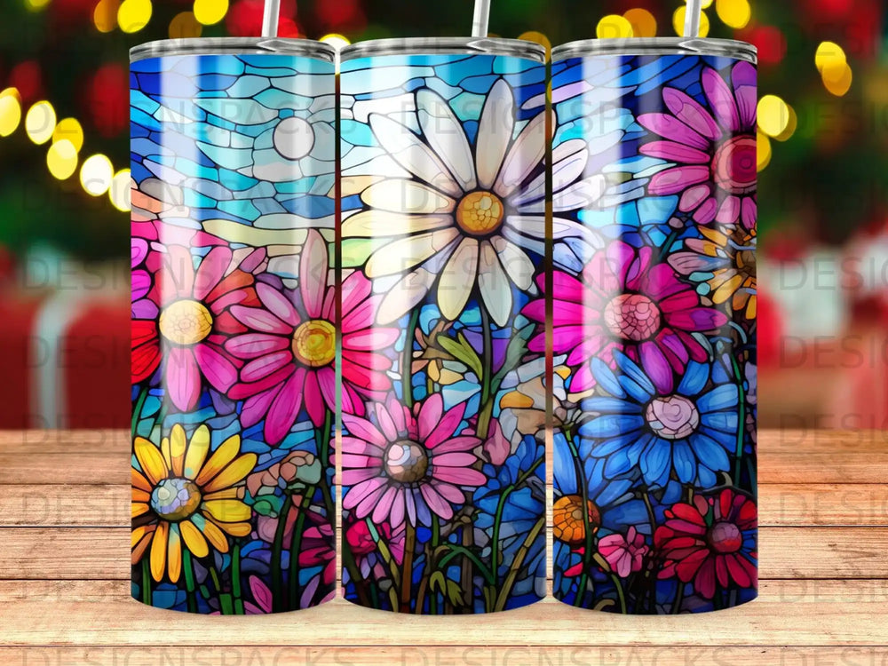 Stained glass art featuring colorful daisies and green foliage on a blue sky background.