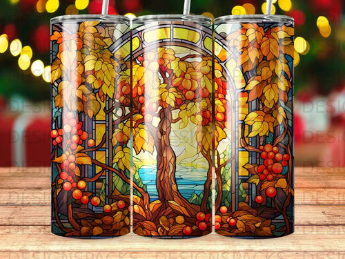 Stained glass window depicting autumn trees and fruit, with a landscape view.