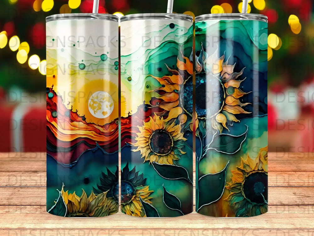 Three tumblers with a vibrant sunflower and sunset landscape design.