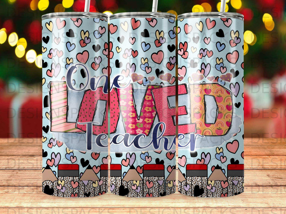 Tumbler with "One Loved Teacher" text and pencil and heart patterns.