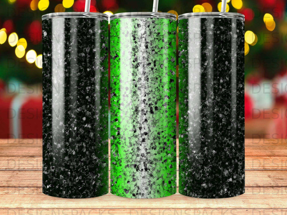 Three tumblers with black and green glitter designs on a blurred background.