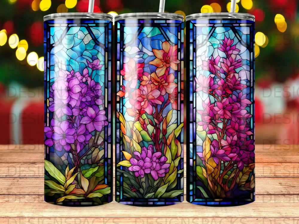 Three tumblers with stained glass floral designs of purple, pink, and orange flowers.