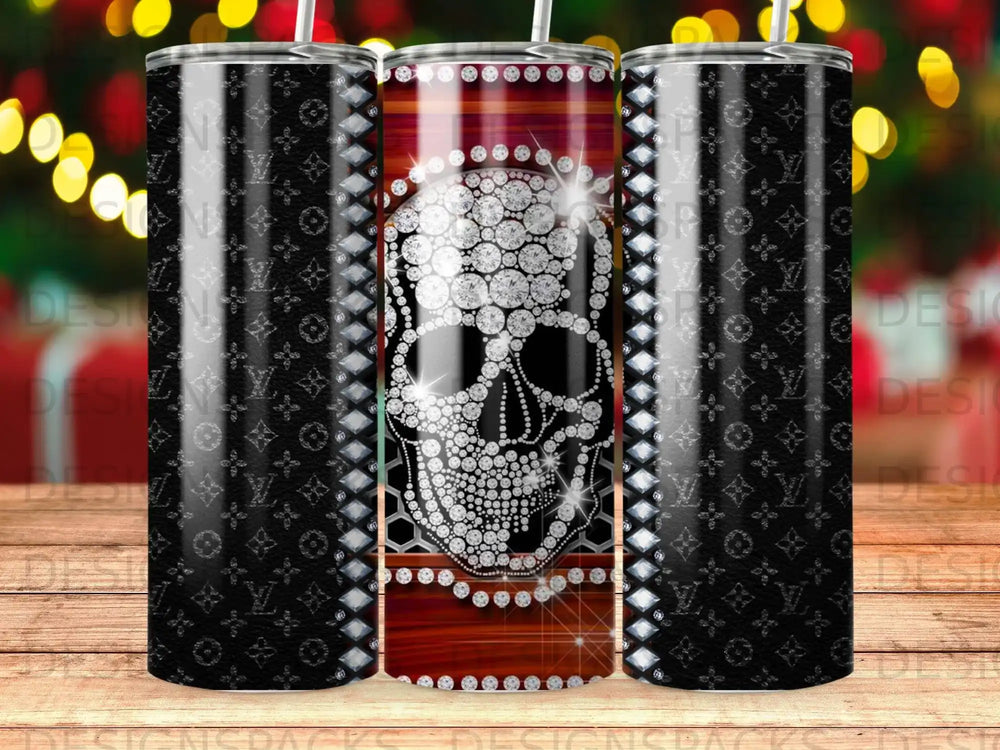Glittering skull with diamond accents on a patterned tumbler.