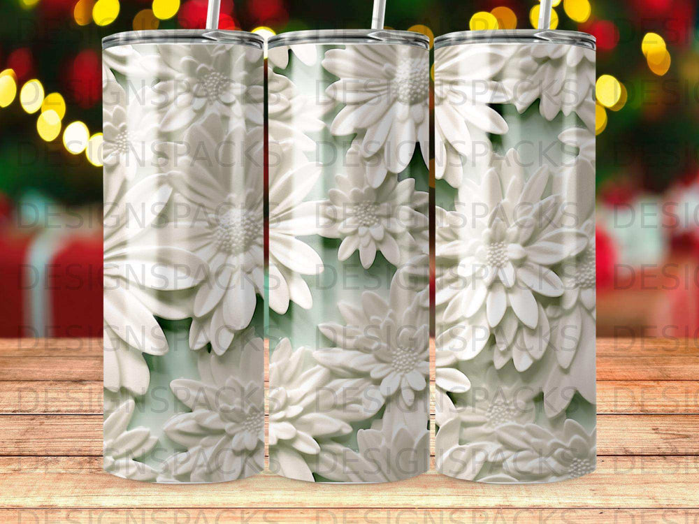 White floral pattern on a skinny tumbler with blurred bokeh lights background.