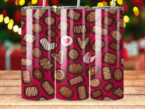 Assortment of chocolate candies with swirling patterns and heart shapes on dark pink background.
