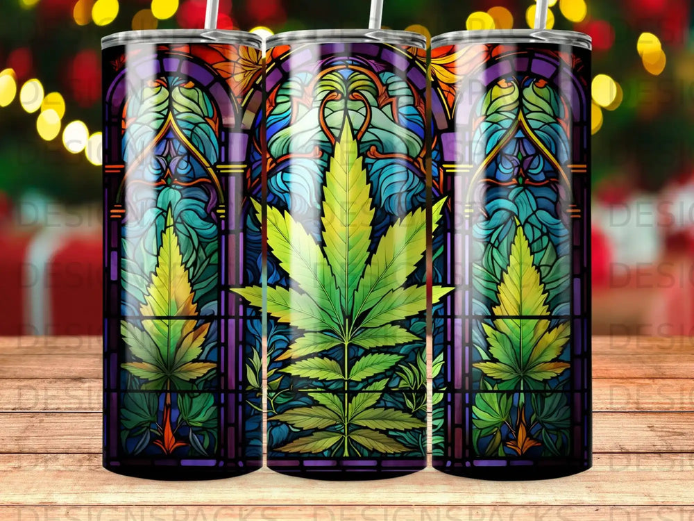 Stained glass tumbler with three cannabis leaves and decorative borders.