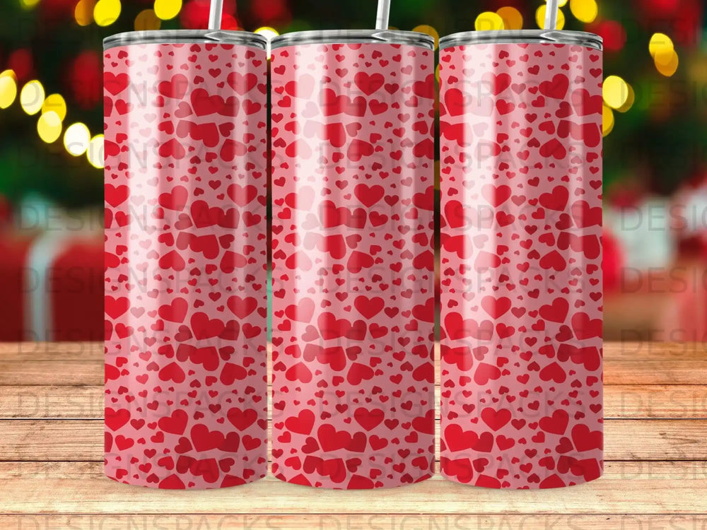 Three tumblers with a repeating pattern of red hearts on a pink background.