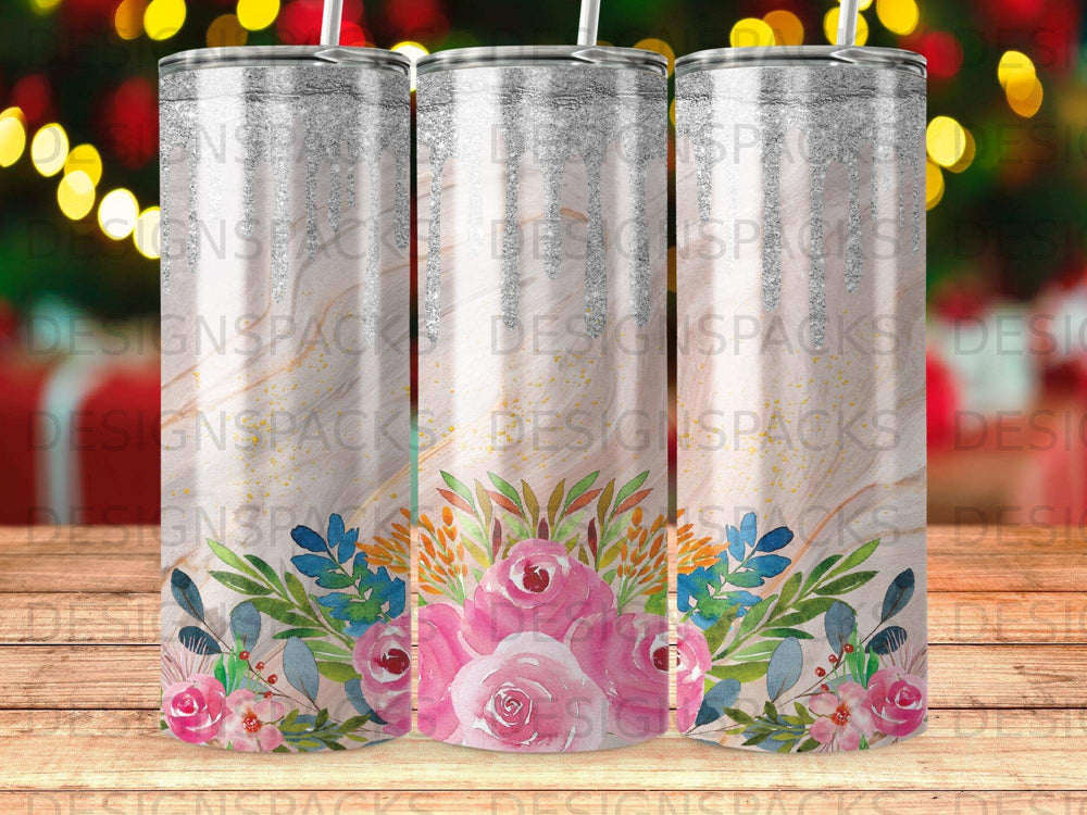 Pink floral design on a skinny tumbler with a silver lid and straw.