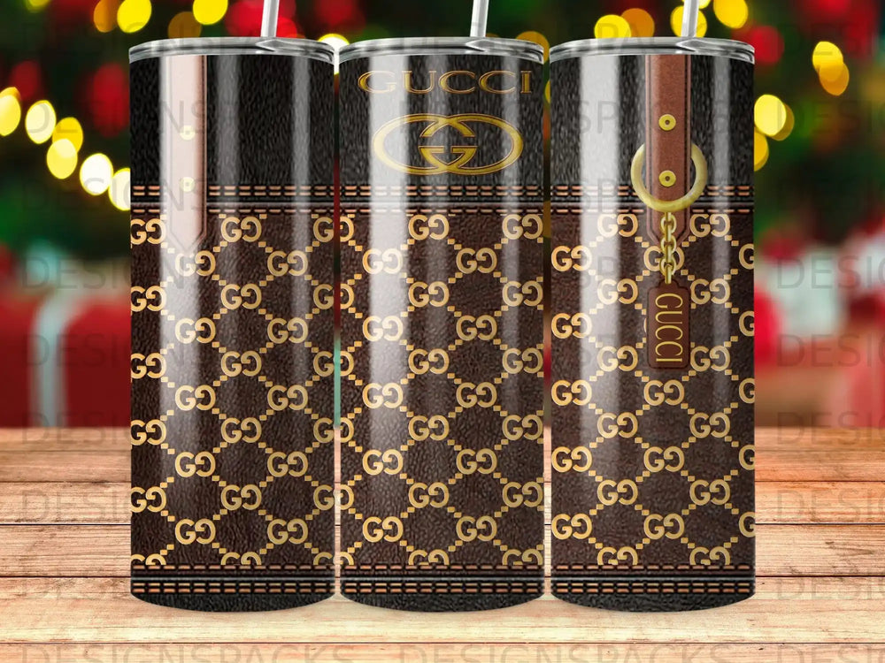 Gucci tumbler with brown leather and gold GG pattern.