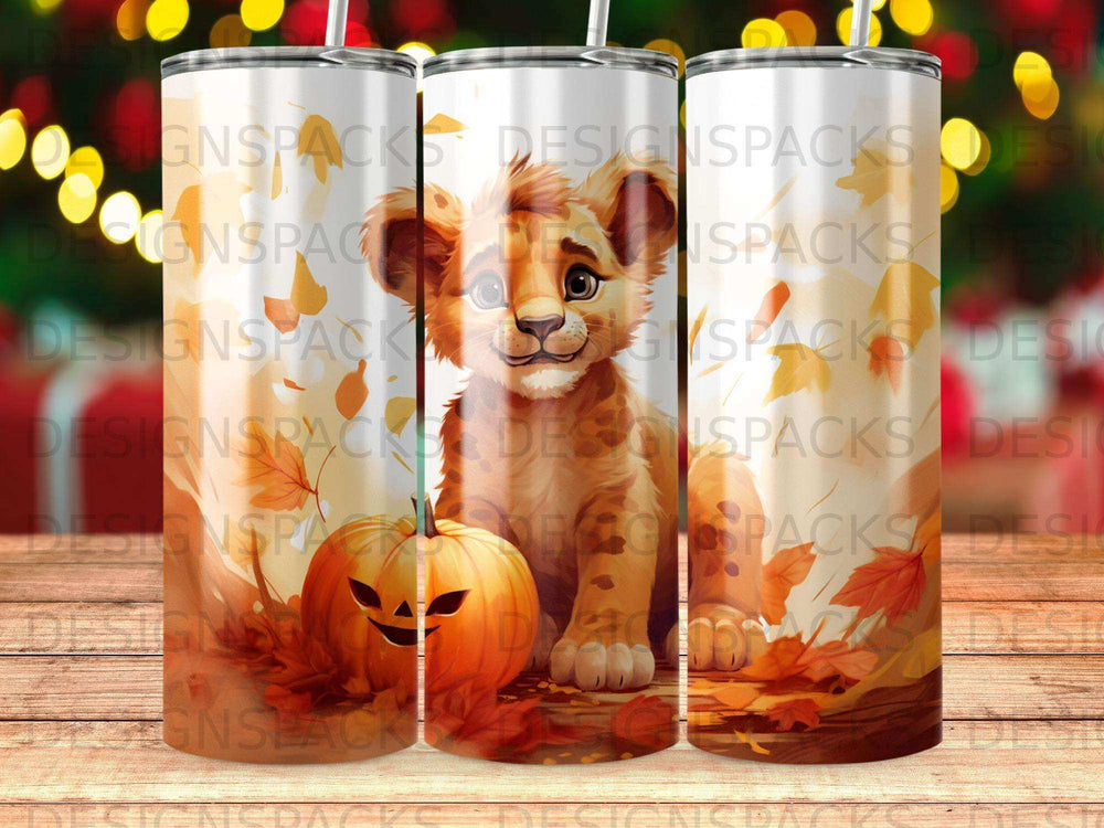 Lion cub with pumpkin and autumn leaves on a tumbler.