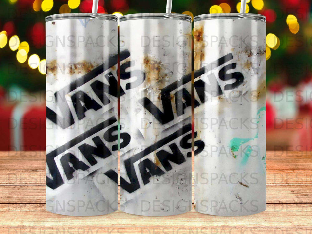 Three tumblers with the Vans logo against a blurred festive background.