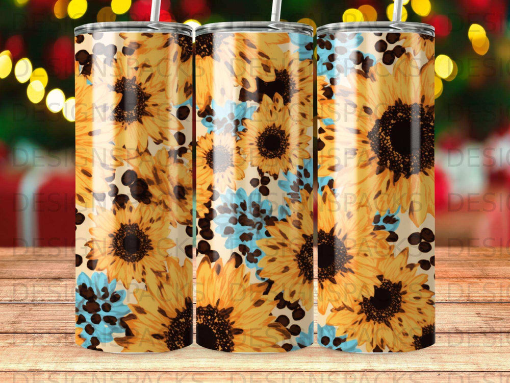 Sunflower pattern on a tapered tumbler with bokeh lights in background.