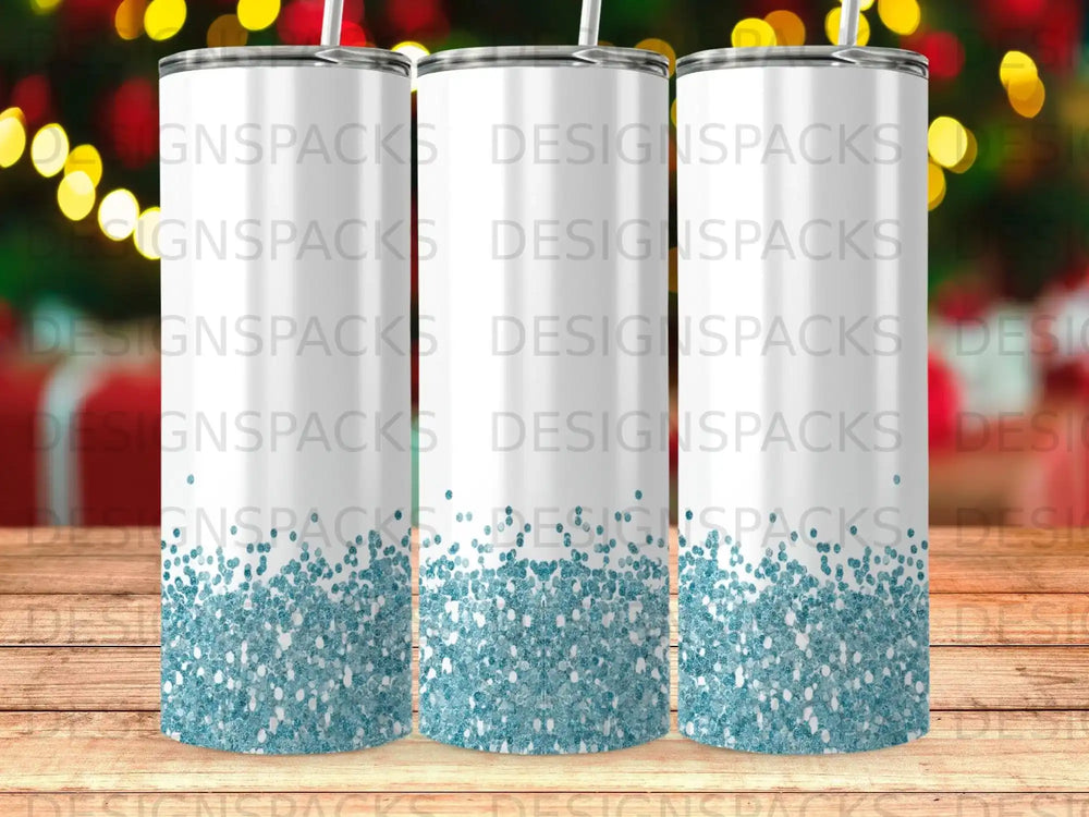 Three blank white tumblers with glitter detail at the bottom.