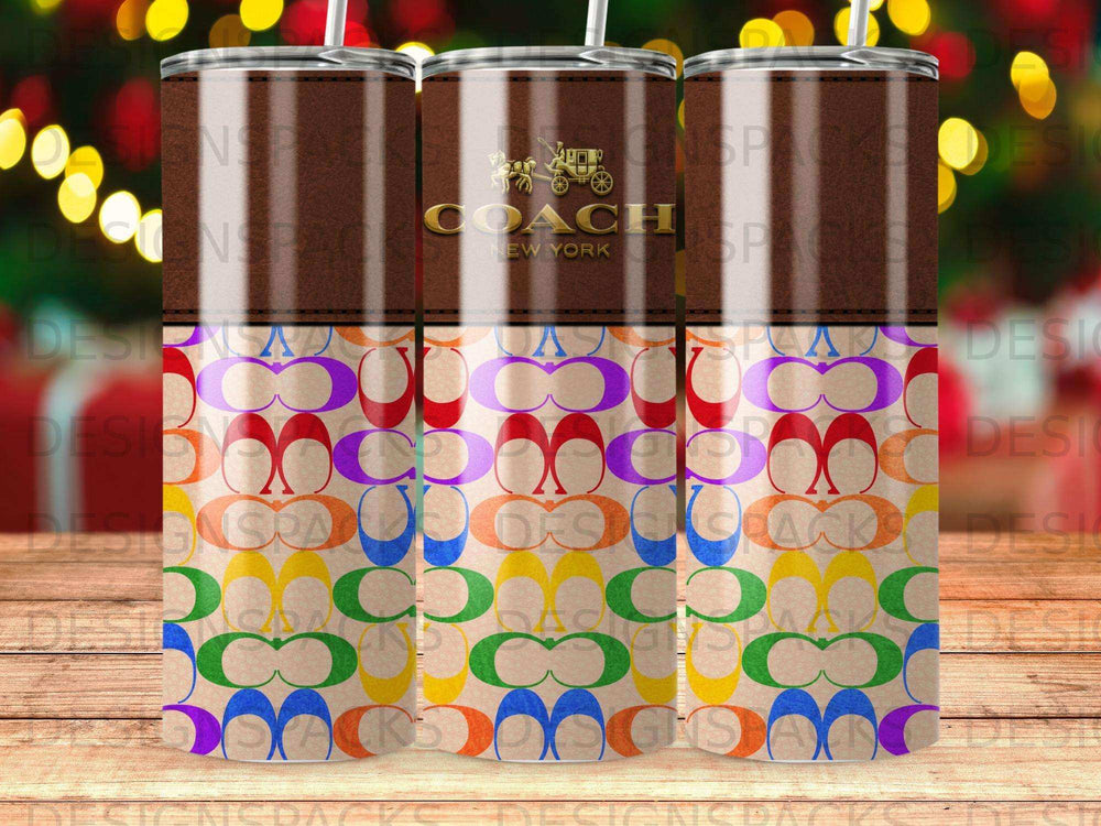 Coach New York tumbler with rainbow monogram pattern.