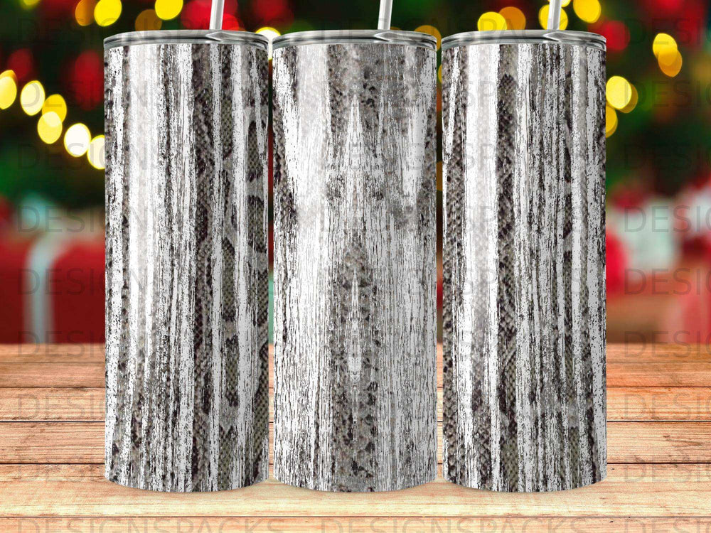 Three skinny tumblers with a faux snakeskin and wood grain pattern.