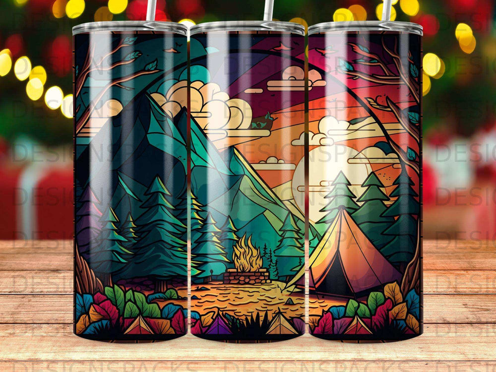 Mountain campsite with tent and campfire under colorful sunset sky.