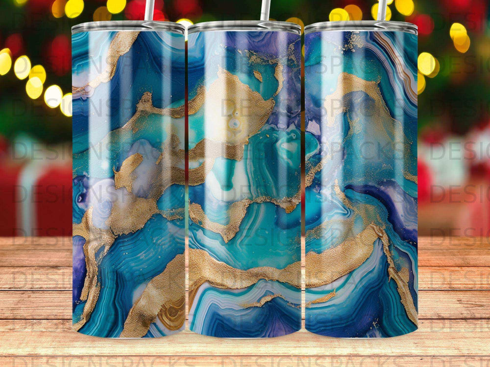 Blue and gold marbled tumbler design with blurred bokeh lights background.