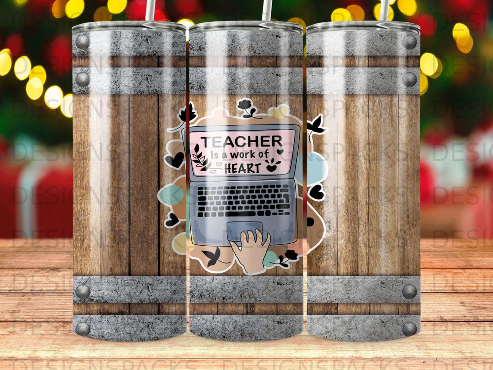 Laptop with "Teacher is a work of heart" text and hand, on wood barrel background.