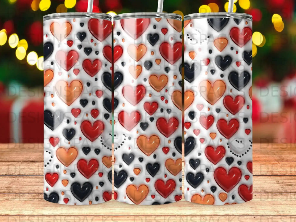 Tumbler with repeating pattern of red, orange, and black hearts on a white background.