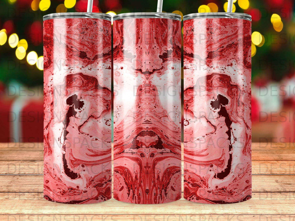 Red marbled pattern on a set of three tumblers with bokeh lights in background.