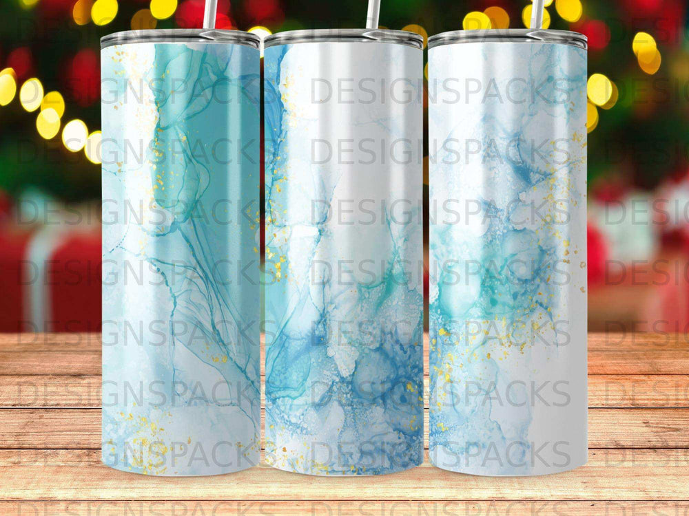 Three tumblers with blue and gold abstract ink patterns.