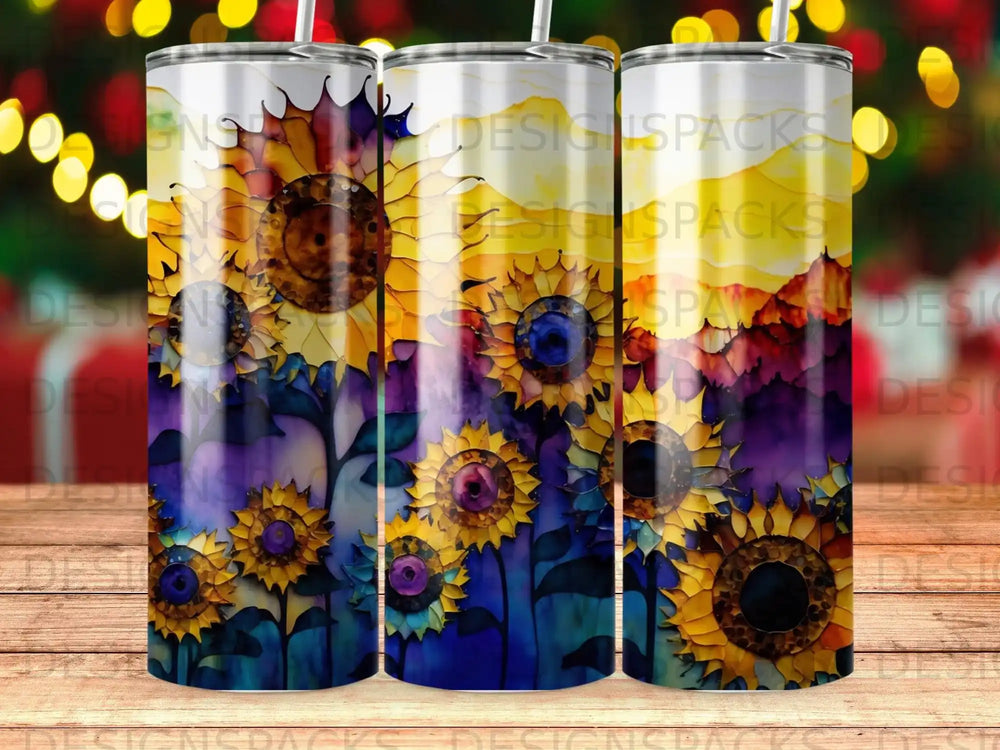 Three tumblers with sunflowers and a sunset watercolor design.