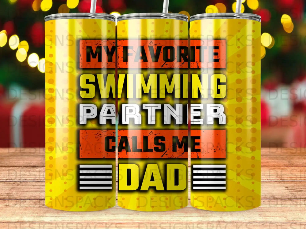 Yellow tumbler with "My Favorite Swimming Partner Calls Me Dad" text.