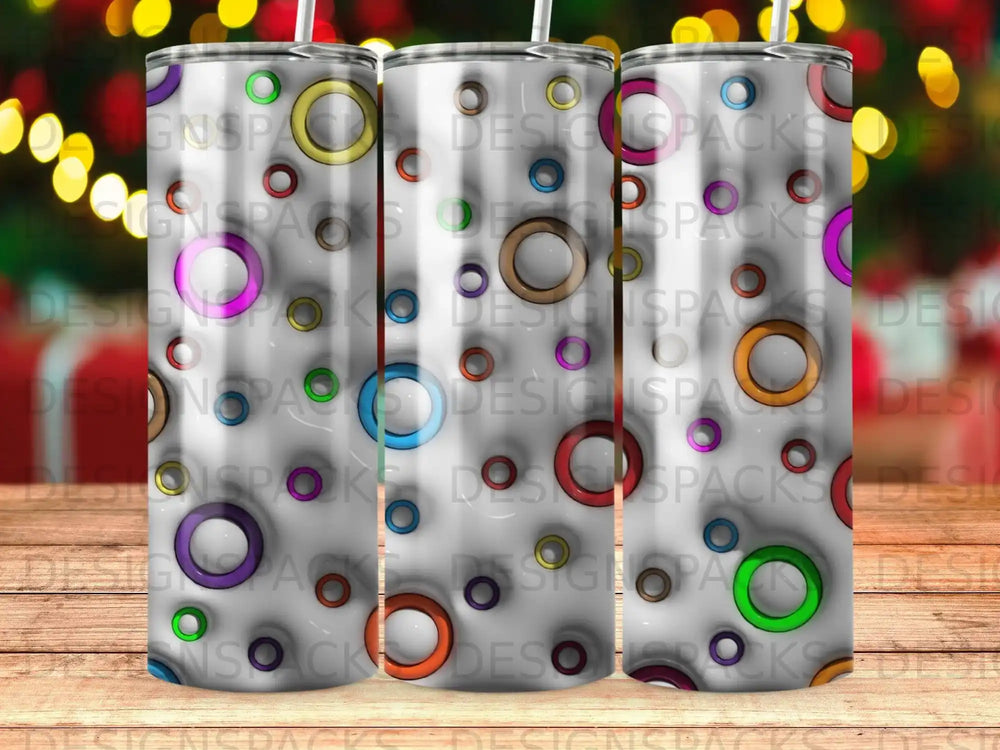 Tumbler with colorful concentric circles and abstract geometric patterns.