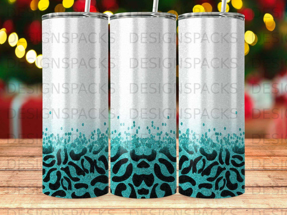 Three white tumblers with teal leopard print at the bottom.