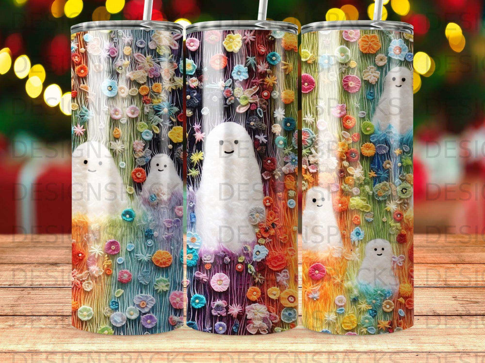 Three tumblers with ghost and floral designs on a blurred background.
