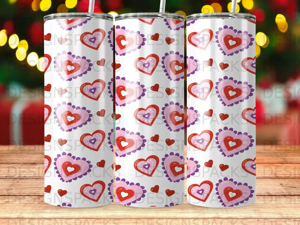 Three tumblers with repeating pattern of pink and red hearts.
