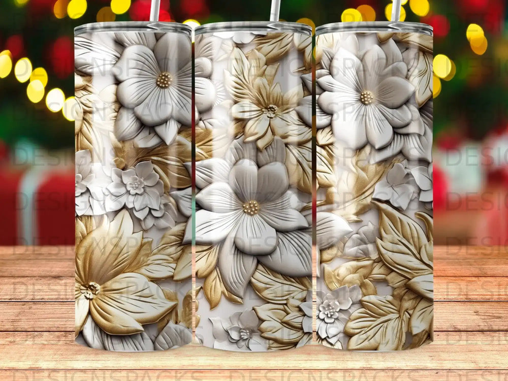Embossed white and gold floral pattern on a tumbler against a blurred background.