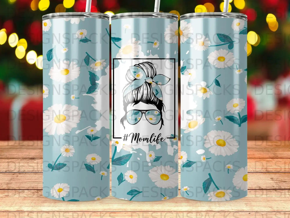 Blue tumbler with daisies and "#Momlife" text.