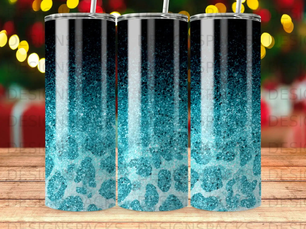Three tumblers with a gradient of black to teal leopard print glitter.