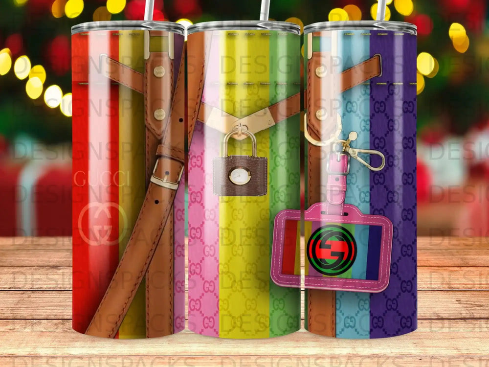 Three tall tumblers with Gucci GG logo pattern and gold buckle accents.