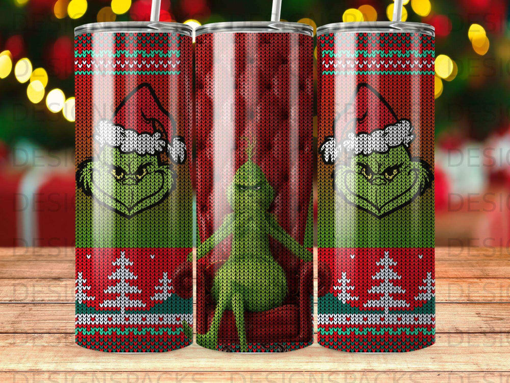 Green Grinch wearing Santa hat on red striped background, festive pattern tumbler.
