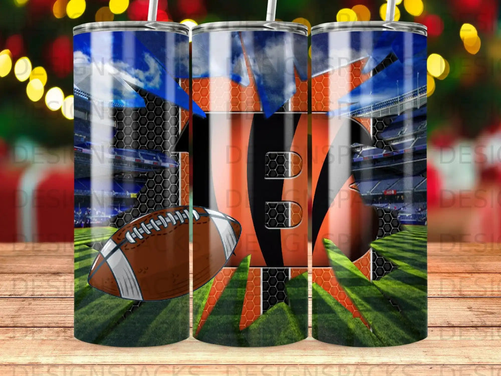 Football stadium backdrop on a tumbler with orange and black stripes.