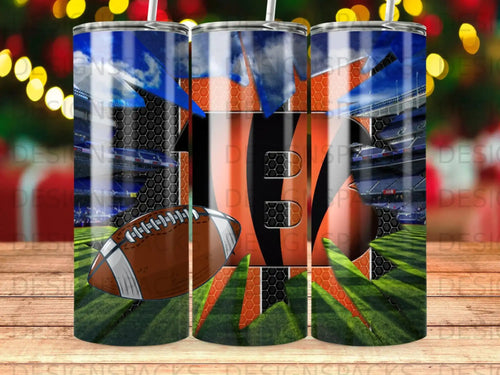 Football stadium backdrop on a tumbler with orange and black stripes.
