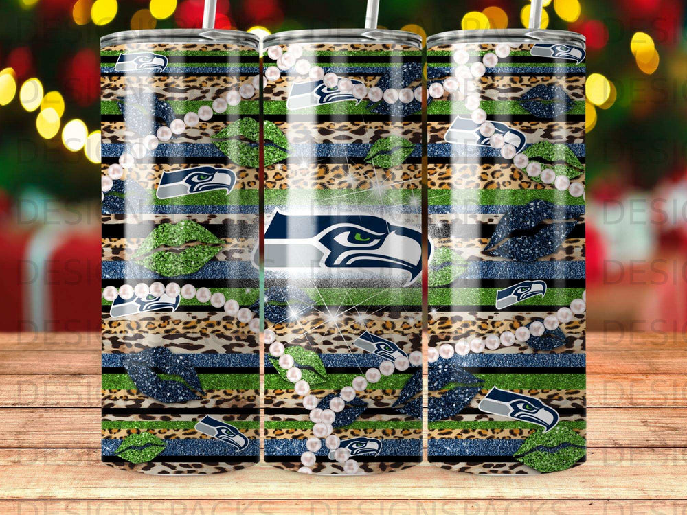 Seattle Seahawks logo with glitter, leopard print, pearls, and lips on striped tumbler.