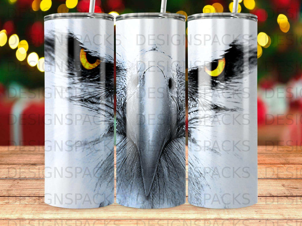 Close-up of a hawk's face on a white tumbler with watermarks.