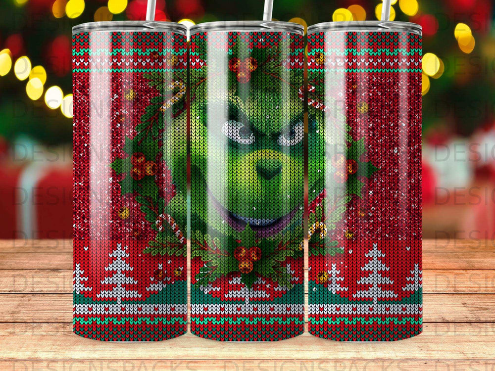 Grinch face on a festive, knit-patterned Christmas tumbler.