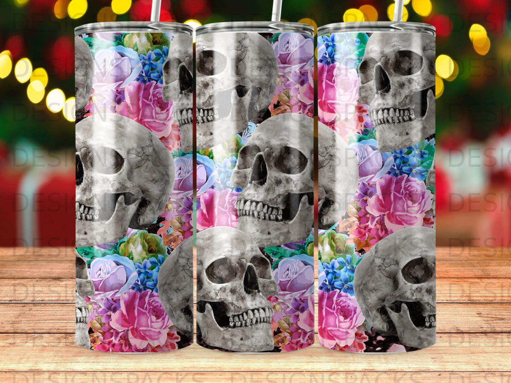 Skulls and colorful flowers adorn a cylindrical tumbler.