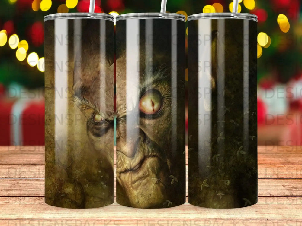 Grinch's face on a tumbler with a blurry Christmas tree background.