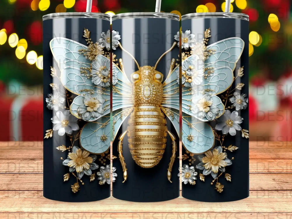 Gold and blue butterfly with floral accents on a dark tumbler.