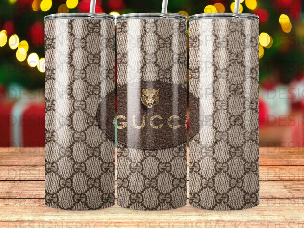 Brown Gucci pattern tumbler with gold logo.