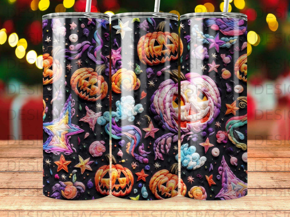 Three tumblers with colorful Halloween pumpkin and star patterns on a dark background.