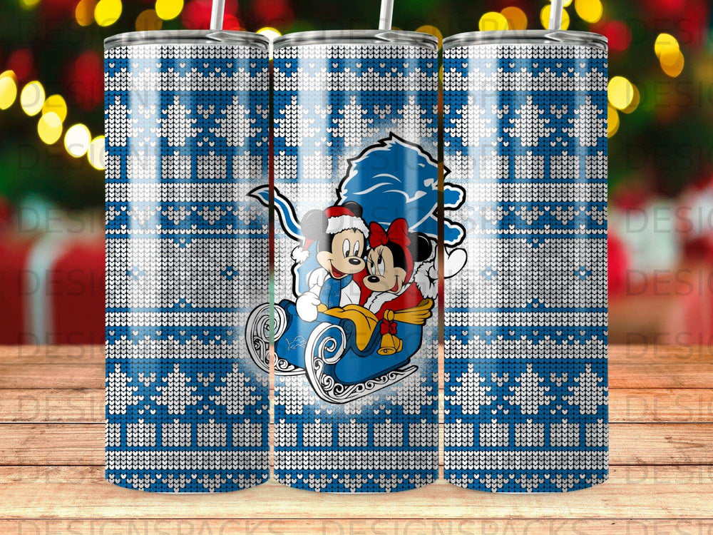 Mickey and Minnie Mouse in a sleigh on a blue and white snowflake pattern tumbler.