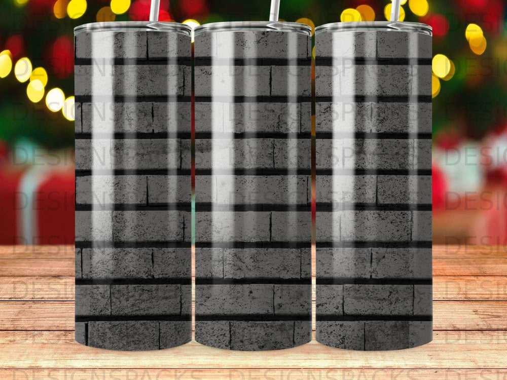 Gray brick pattern tumbler with blurred festive lights in the background.
